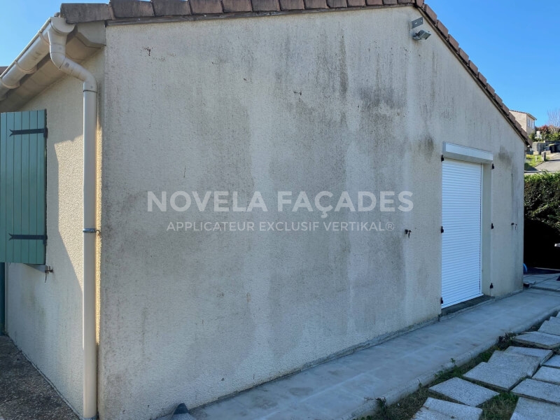 Façade de maison avec volets verts et porte de garage